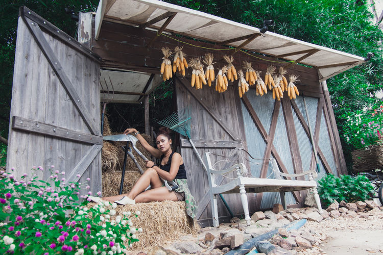 Portrait of woman sitting in barn