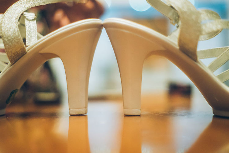 Close-up of high heels on hardwood floor