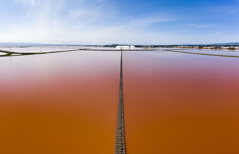 Aerial of vivid pink salt evaporation ponds in sf bay marshland