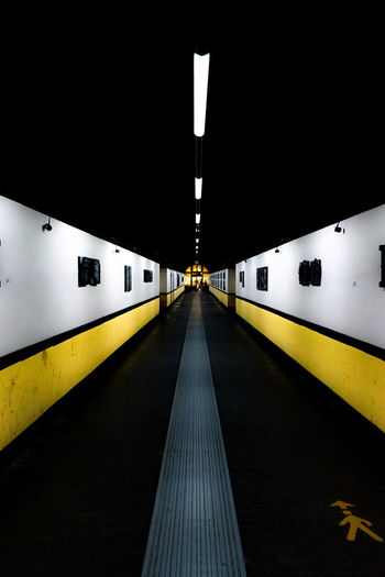 Illuminated railroad station platform at night