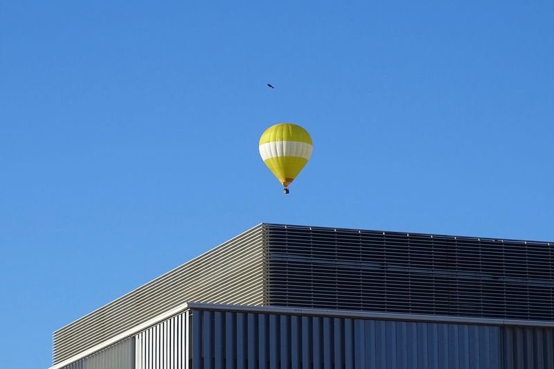 Low angle view of hot air balloon against clear blue sky
