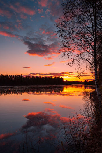 Scenic view of lake against romantic sky at sunset