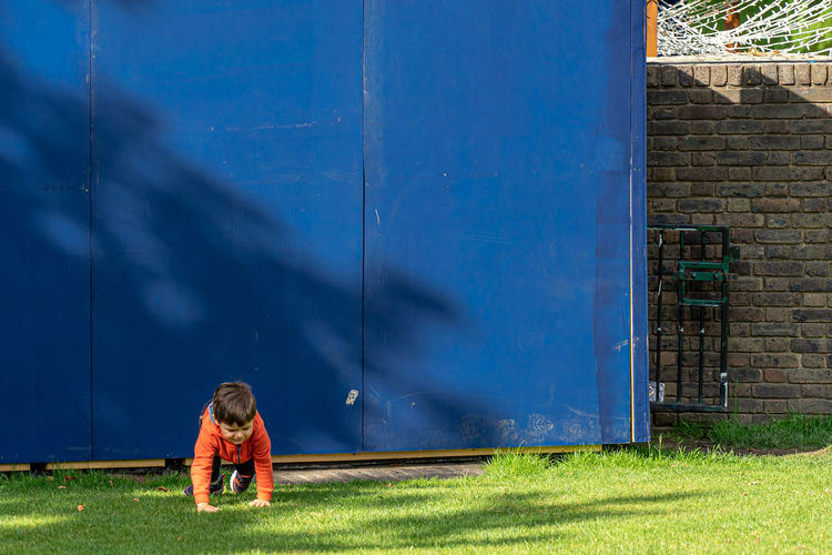 Rear view of boy on wall
