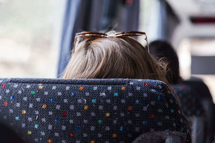 Woman wearing sunglasses in bus