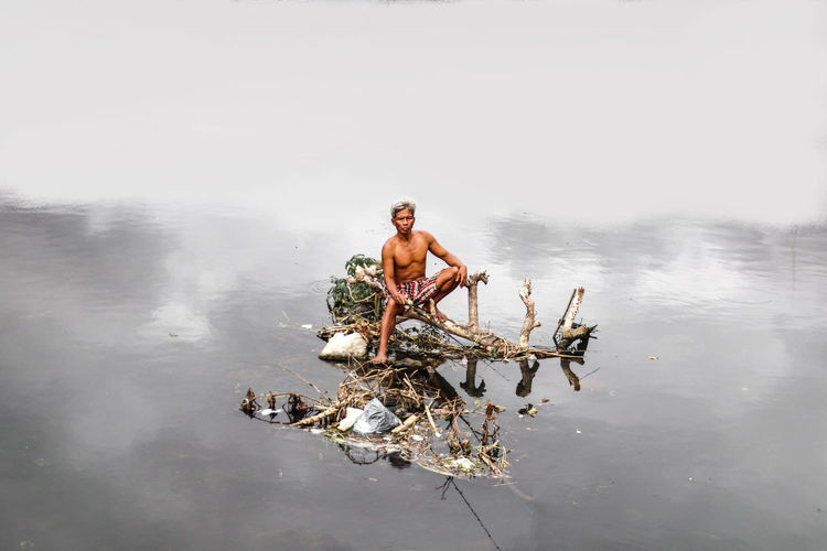 Rearview of a man floating on the water
