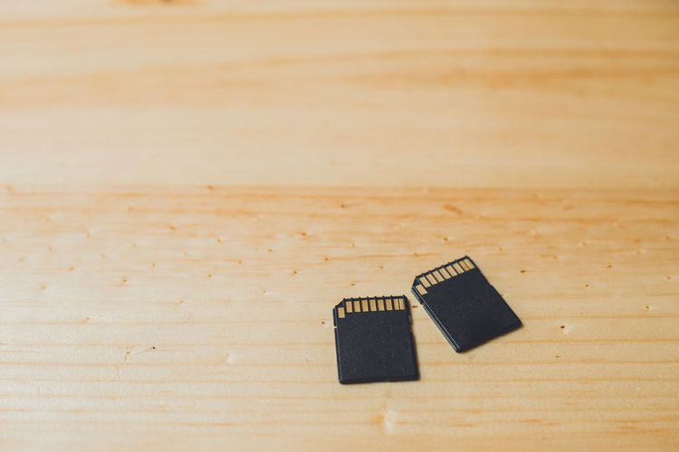 High angle view of memory cards on wooden table