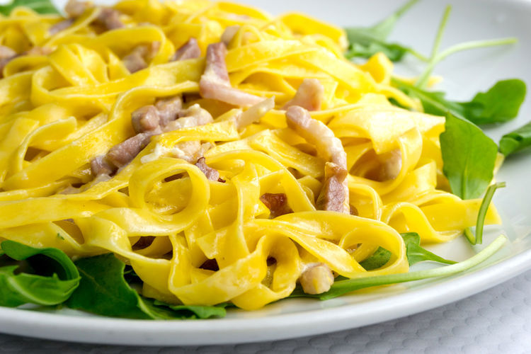 Close-up of carbonara pasta served in plate on table