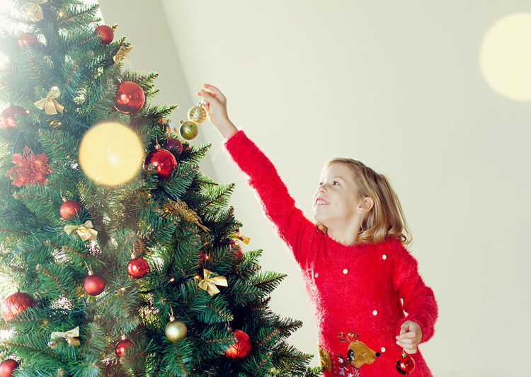 Portrait of girl decorating christmas tree