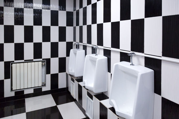 A bright creative toilet, the interior is made of black and white tile.