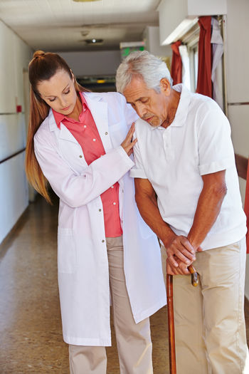 Doctor assisting patient at hospital