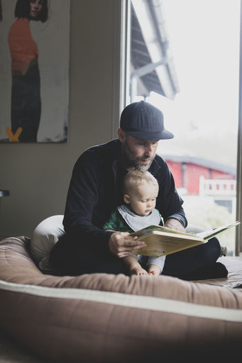 Father reading book for baby son