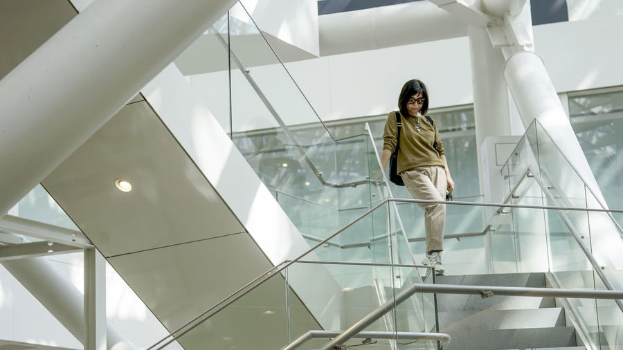 Low angle view of woman standing on staircase