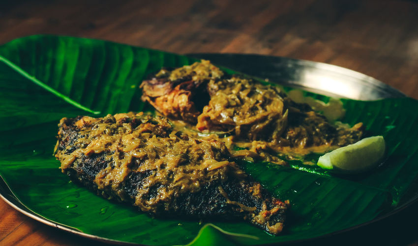 Bengali fish curry, telapia on banana leaf, selective focus