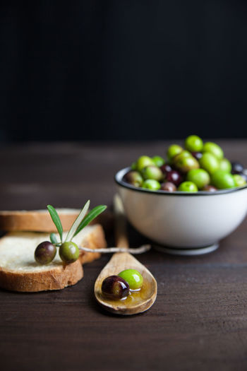 High angle view of green olives and bread on table