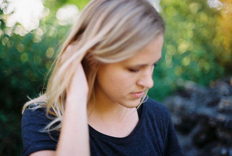 Close-up portrait of young woman looking away outdoors