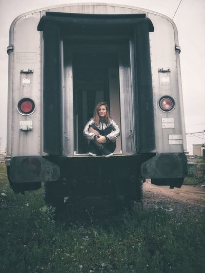 Portrait of woman sitting on vehicle