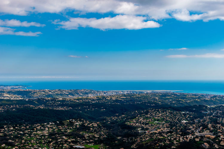 Aerial view of city and sea against sky
