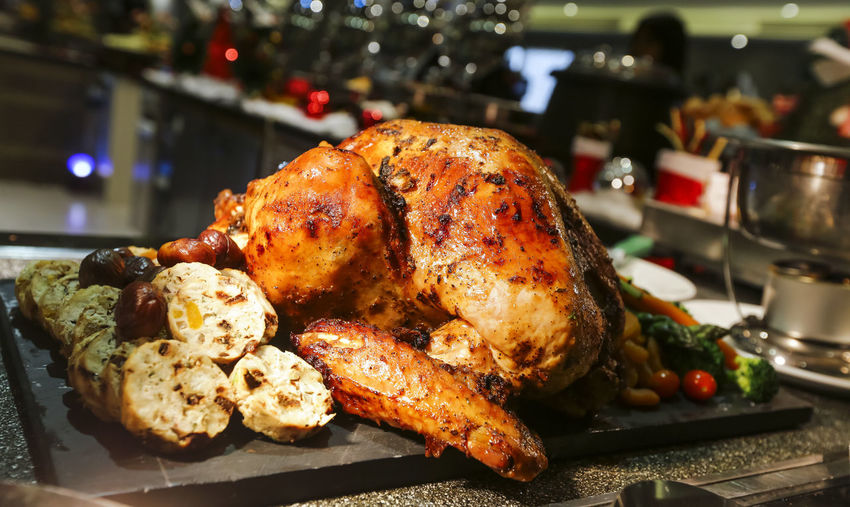 Close-up of roasted chicken on slate