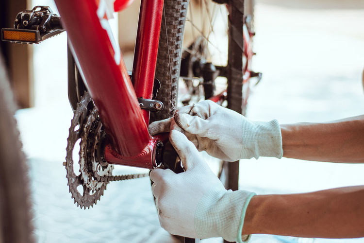 Cropped hands of person repairing bicycle