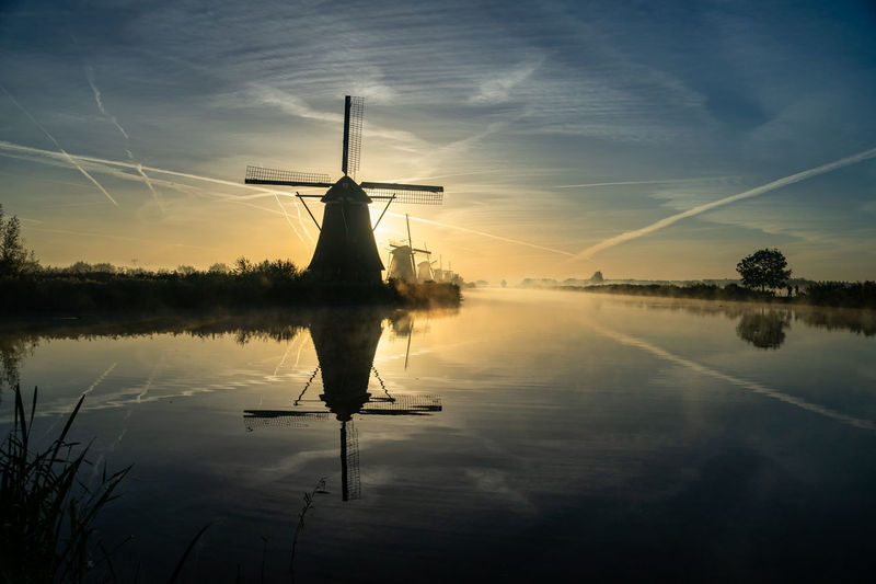 Scenic view of lake against sky during sunset, windmill, kinderdijk