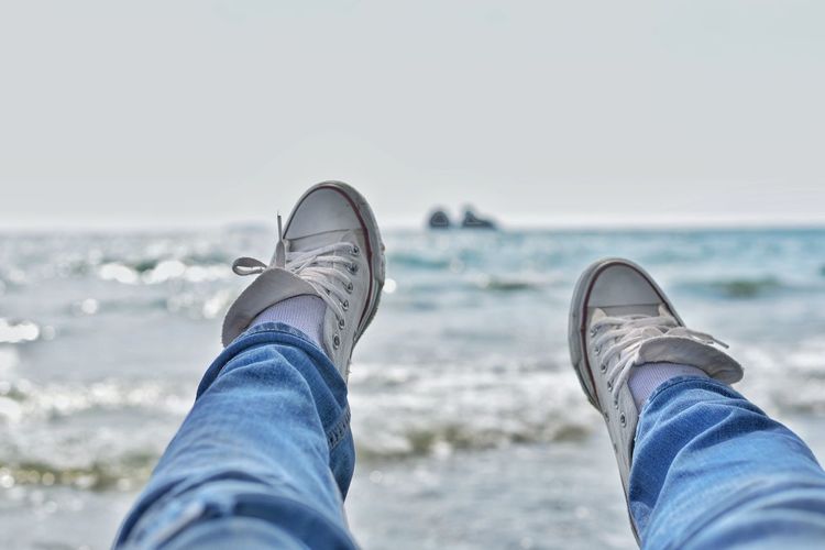 Man's feet on the beach, relaxing on the beach