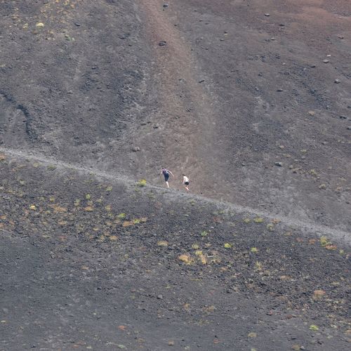 Low angle view of hikers hiking on mt etna