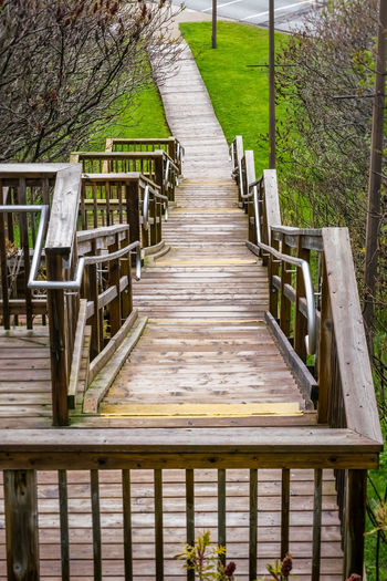 Wooden footbridge over footpath in park