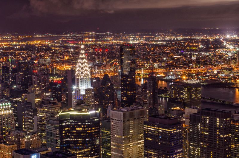 Aerial view of city lit up at night