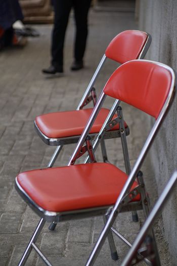 Low section of people on empty chair