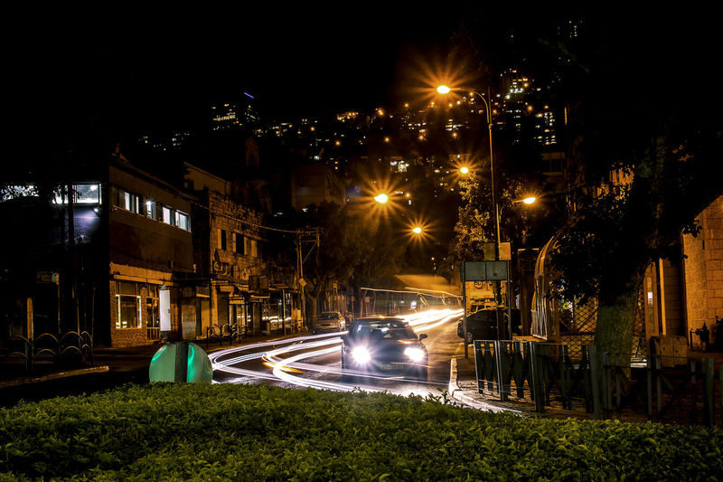 Illuminated light trails on street in city at night