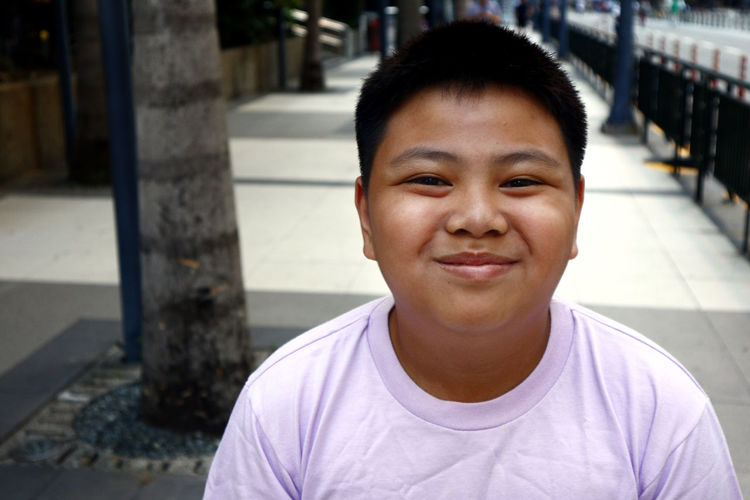 Portrait of a young filipino boy taken outdoor at a business district