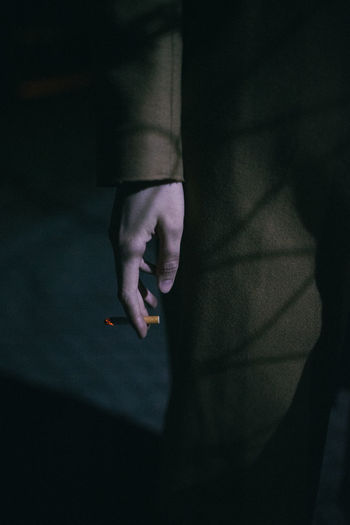 Close-up of woman holding cigarette