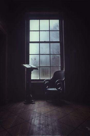 Chair and bookstand by window at home