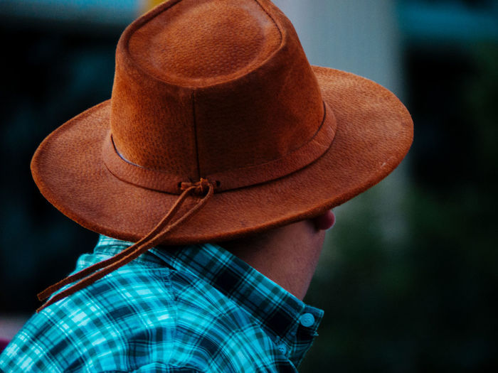 Rear view of person wearing hat standing outdoors