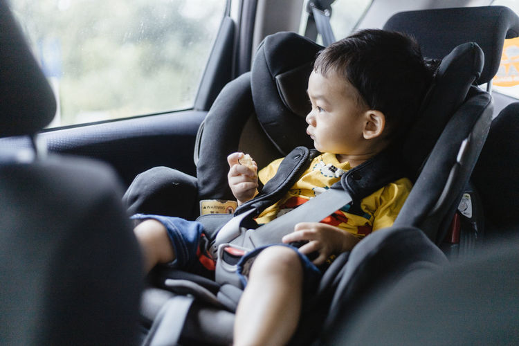 Baby boy sitting in car