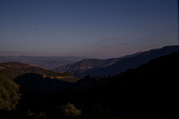 Scenic view of silhouette mountains against sky at sunset