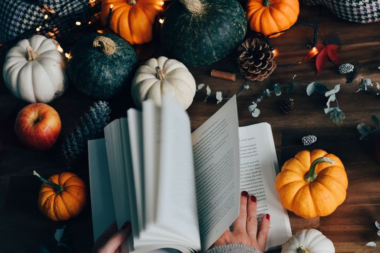 High angle view of pumpkins and book on table