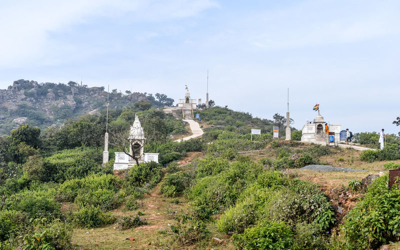 Panoramic view of temple amidst trees and buildings against sky