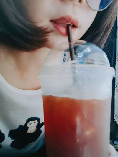Close-up of woman drinking juice