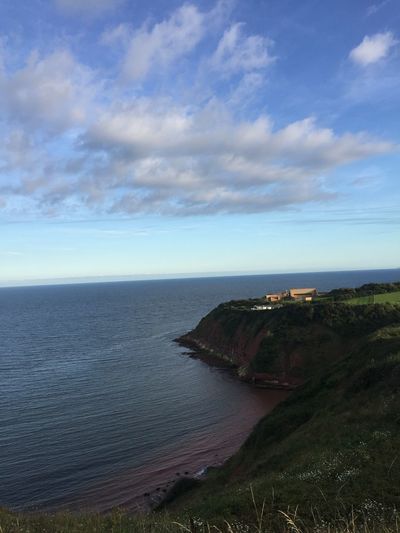 Scenic view of sea against cloudy sky