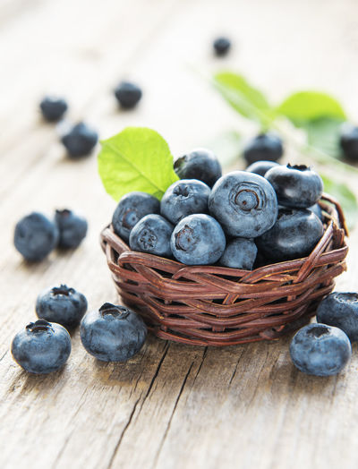 Freshly picked blueberries on a old wooden background. concept for healthy eating