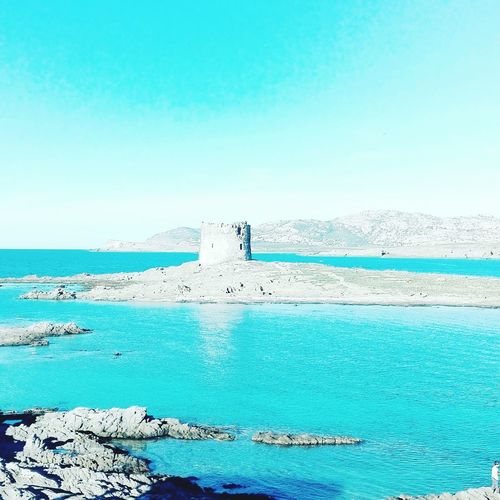 Scenic view of sea against clear blue sky