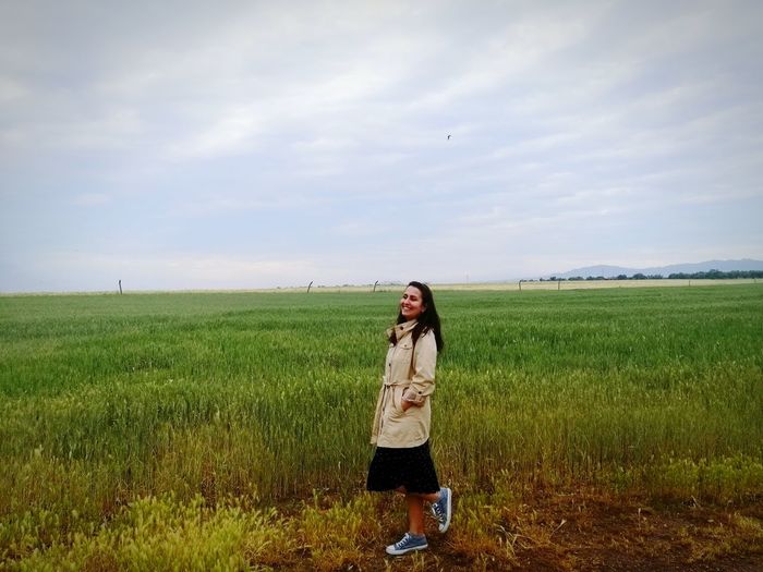 Full length of man standing on field against sky