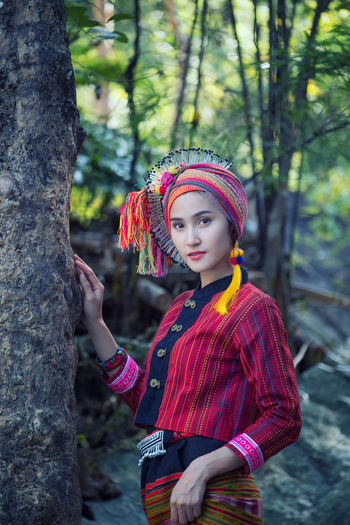 Portrait of woman in costume standing by tree