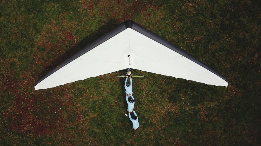 High angle view of paragliding on field