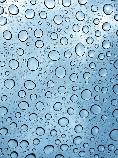 Full frame shot of wet glass in rainy season