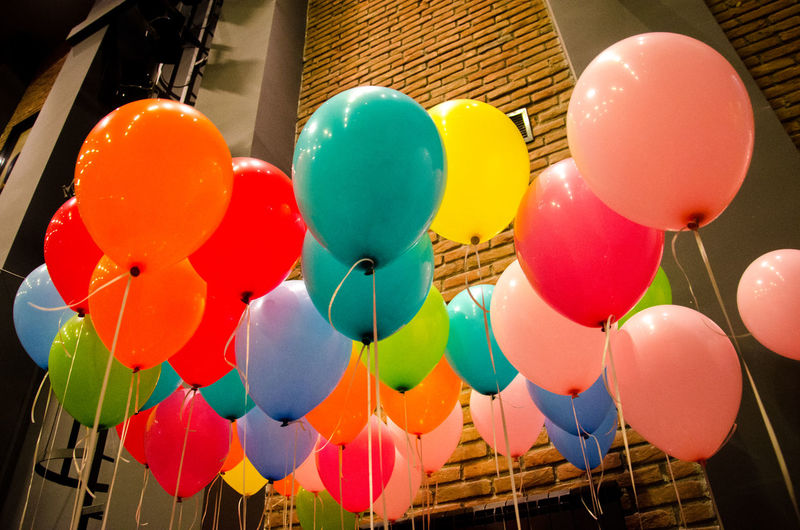 Low angle view of multi colored balloons