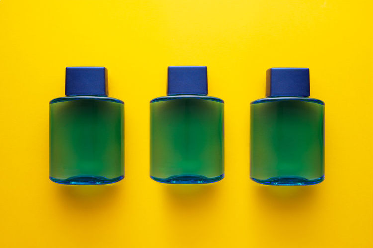 Close-up of bottles against yellow background