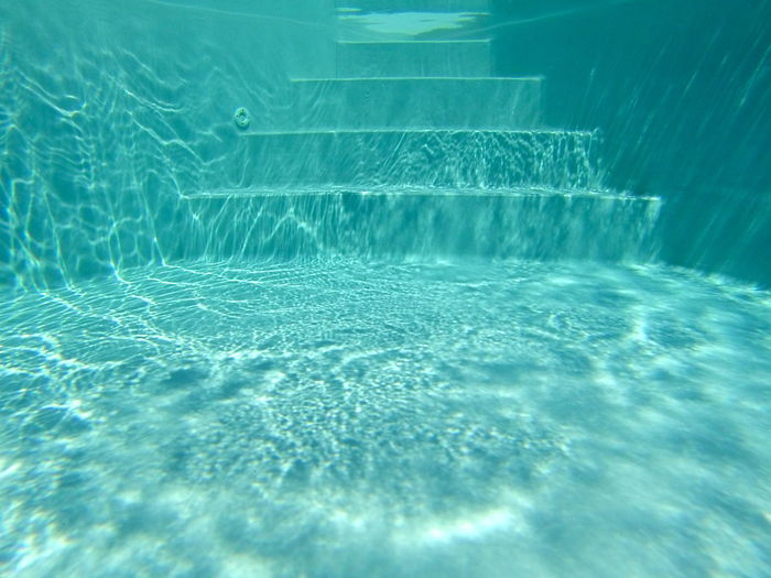 Steps in turquoise swimming pool