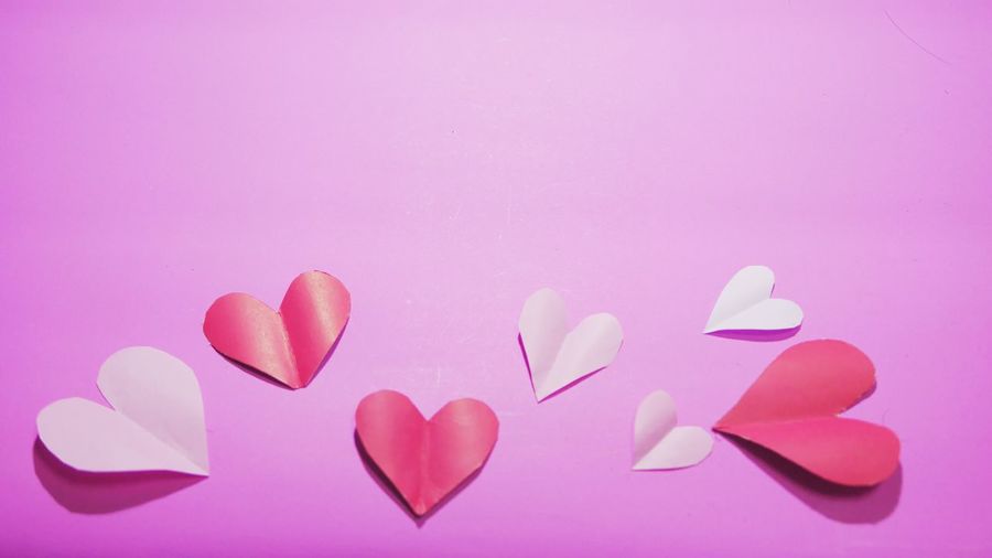 Close-up of pink heart shape over white background